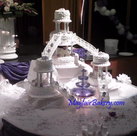 &quot;Beth&quot; in Lavender - This is a modified version of the classic tiers with stairs cake we made for cousin Beth.Each set of cakes is elevated with boxes under the tablecloth.&amp;nbsp;